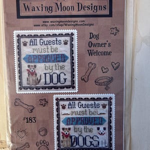 May include: A cross-stitch pattern packet with the text "Waxing Moon Designs." The design features two cross-stitch patterns with the text "All Guests must be APPROVED by the DOG" and "All Guests must be APPROVED by the DOGS."