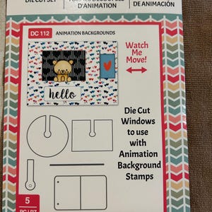 May include: A Motion Crafts animation die cut set. The package features a bear illustration, the word "hello", and the text "Watch Me Move!". Includes die cut windows to use with animation background stamps.
