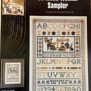 May include: A cross-stitch sampler pattern featuring the alphabet, numbers, and a quote from Proverbs 31:31. The sampler is titled "Virtuous Woman Sampler" and is designed by Elizabeth Spurlock. The frame size is 14.5 inches by 18.5 inches.