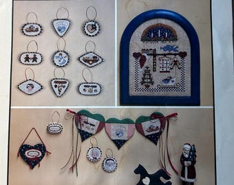 HeartStrings Cross Stitch Patterns The Santa Factory April & June, The Heart of the Matter and A Cranberry Christmas