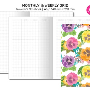 May include: An A5 size traveller's notebook with a monthly and weekly grid layout. The notebook has a floral pattern on the cover with a white background and colourful pansies.