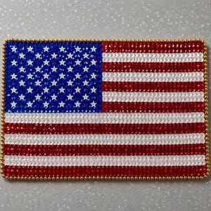 May include: A rectangular patch featuring the United States flag design, constructed from numerous small, reflective red, white, and blue sequins. The flag is bordered by a thin, metallic gold beaded trim that frames the entire rectangular shape.