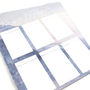 May include: A stack of prayer request cards with a watercolor design. The cards have a blue and white color scheme with the words "Prayer Requests" in script. Each card has six white boxes for writing.