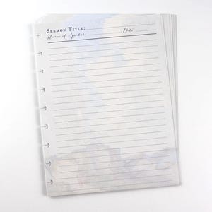 May include: A stack of lined paper with the text "Sermon Title: Name of Spider" at the top. The paper has a watercolor design at the bottom and is held together with a ring binder mechanism.