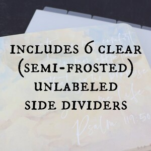 May include: A planner with gold rings and a watercolor design. The text reads "INCLUDES 6 CLEAR (SEMI-FROSTED) UNLABELED SIDE DIVIDERS". The dividers are gray and the background has a soft, pastel color scheme.