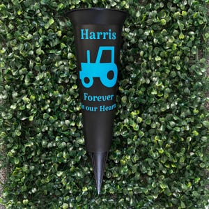 May include: Black plastic flower vase with a blue tractor silhouette and the text "Harris Forever in our Hearts".