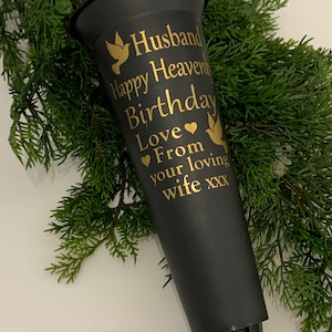 Può includere: Vaso in plastica nera con un'iscrizione dorata che recita "Husband Happy Heavenly Birthday Love From your loving wife xxx".