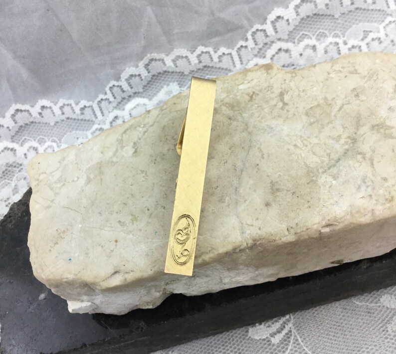 Vintage Midcentury Mens Designer Gold Tone Tie Bar Clasp by Swank Textured Patina with Engraved Detail