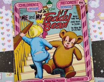 May include: A vintage children's record book cover featuring a cartoon boy and teddy bear walking up stairs. The cover is red, white, and yellow with the title "Me and My Teddy Bear" and the text "Children's Records Songs 99p".