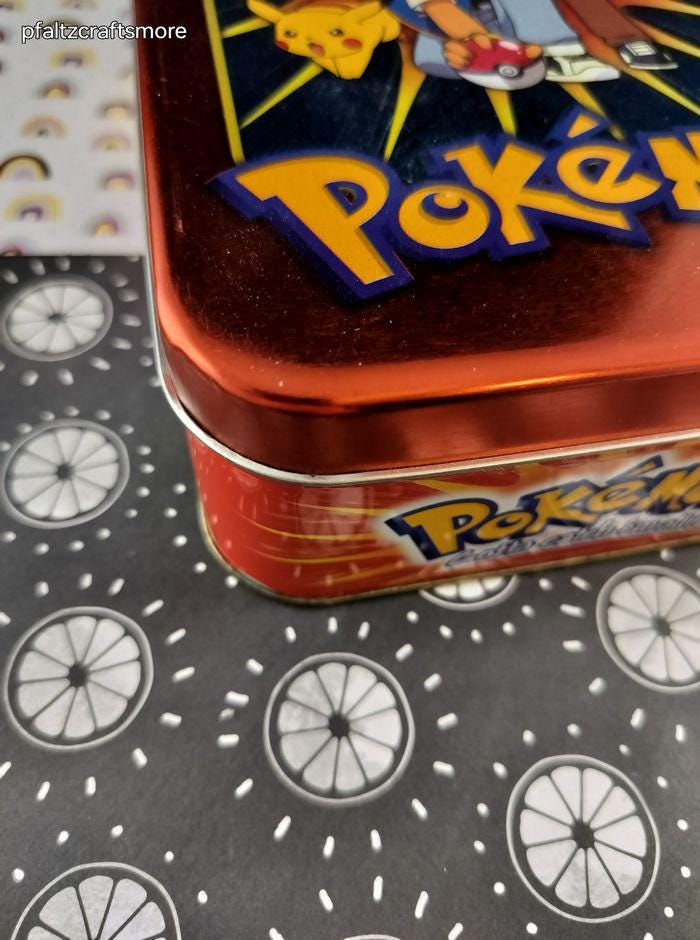 pokemon card tin Lumiose City Mini adding a touch of charm to your Pokémon gear Pokémon Paldean Fates Tin |