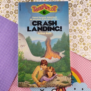 May include: A book cover with the title "Crash Landing!" from the "Twistaplot" series. The cover features a young man and woman looking scared as they stand near a burning forest.