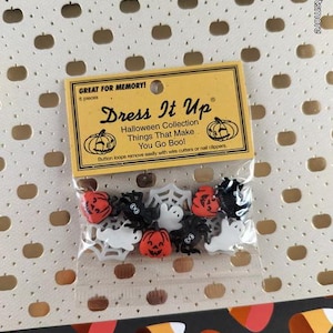 May include: A clear plastic package containing six Halloween-themed buttons, including orange pumpkins, black spiders, white ghosts, and a white spider web. The yellow header card reads Dress It Up, Halloween Collection, Things That Make You Go Boo!