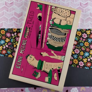 May include: A comic book cover with a pink background and the title "EENIE MELNIE-MINIE-TWEED" in white text. The cover features a cartoon illustration of a monster with a green head and a long, green body. The monster is standing in front of a building with a door and windows. There are other cartoon characters in the background.