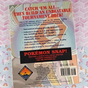 May include: A paperback book titled "Catch 'Em All... Then Build an Unbeatable Tournament Deck!" with a bonus chapter on Pok&eacute;mon Snap for the Nintendo 64. The book includes tournament strategies and collector's guides.