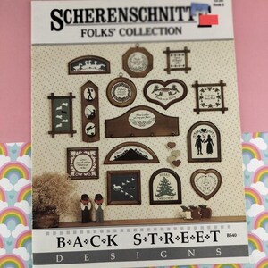May include: A sheet featuring various wooden folk art designs. The designs include framed silhouettes, hearts, and arched shapes with images of geese, couples, and Christmas trees. The text "SCHERENSCHNITT FOLKS' COLLECTION" is at the top.