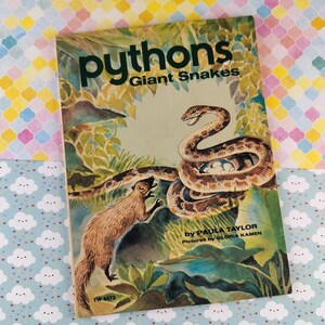 May include: Vintage book cover titled "Pythons Giant Snakes" featuring an illustration of a snake coiled around eggs, a mongoose, and lush foliage. The book is by Paula Taylor, with pictures by Gloria Kamen.