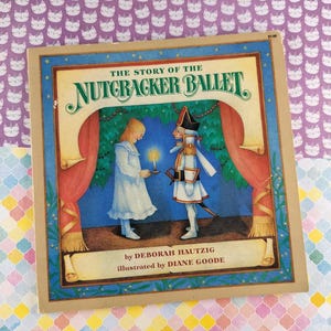 May include: A children's book titled "The Story of the Nutcracker Ballet" with illustrations. The cover shows a girl holding a candle and a Nutcracker soldier on a stage with red curtains. The book is by Deborah Hautzig, illustrated by Diane Goode.