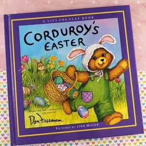 May include: A children's book titled "Corduroy's Easter" with a purple cover and a colorful illustration. The cover art features a bear wearing bunny ears and green overalls, holding a basket of Easter eggs. The book is a lift-the-flap book.