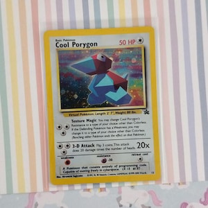 May include: A Cool Porygon trading card with a yellow border and a holographic illustration of the geometric character. The card displays 50 HP, the Texture Magic and 3-D Attack moves, and text detailing the Pokémon's virtual nature and stats.