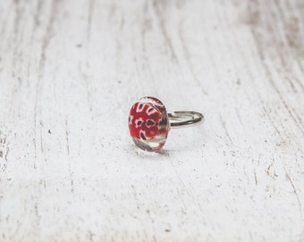 Fused glass ring on adjustable base will fit most sizes. Metal silver colour.