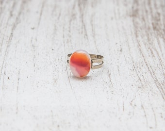 Fused glass ring on adjustable base will fit most sizes. Metal silver colour.