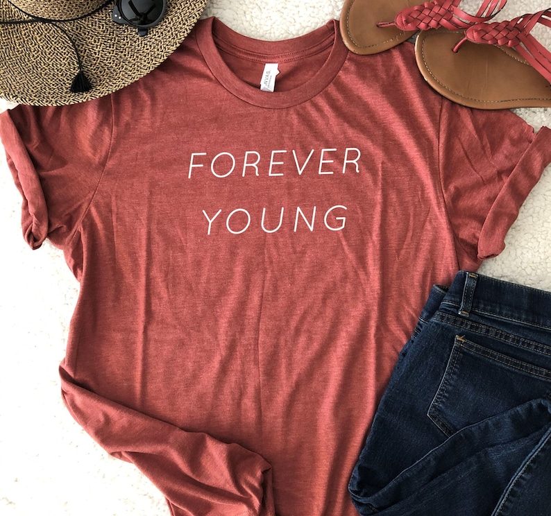 May include: A red t-shirt with the text "FOREVER YOUNG" printed in white on the front.