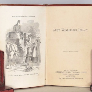 May include: A vintage book titled "Aunt Winefred's Legacy" with an illustration of a horse-drawn carriage and people on the cover. The book is published by the American Sunday-School Union in Philadelphia and New York.