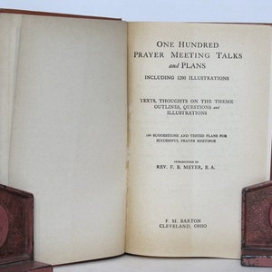May include: A book titled "One Hundred Prayer Meeting Talks and Plans" with 1200 illustrations. The book includes texts, thoughts on the theme, outlines, questions, and illustrations. It also features 100 suggestions and tested plans for successful prayer meetings. The book was introduced by Rev. F. B. Meyer, B.A. and published by F. M. Barton in Cleveland, Ohio.