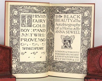 May include: A vintage book titled "Black Beauty: The Autobiography of a Horse" by Anna Sewell. The cover features intricate black and white illustrations with a quote from Shakespeare: "This is fairy gold. Boy: And 't will prove so."