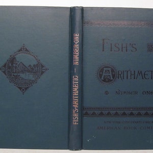 May include: A vintage blue book titled "Fish's Arithmetic - Number One" with a decorative design on the front cover and the publisher's name, "American Book Company", on the back cover.