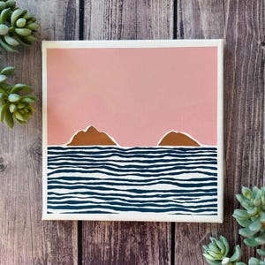 May include: An abstract painting depicting two islands in pink and brown with blue and white striped waves in the foreground.