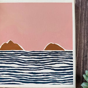 May include: A painting depicting a seascape with two brown islands in the distance and a blue and white striped ocean in the foreground. The sky is a light pink colour.