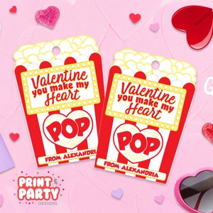 May include: Two printable Valentine's Day gift tags featuring a popcorn box with the text "Valentine you make my heart POP" and "From Alexandria".