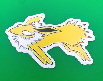 May include: A yellow and white cartoon sticker of a Pokemon character, Jolteon, with spiky hair and a lightning bolt tail. The sticker is on a green background.