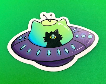 May include: A black cat with one large eye sits inside a purple and green flying saucer with a white outline.