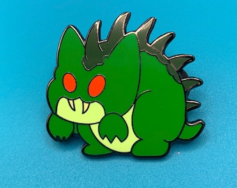 May include: Green monster with black spikes and red eyes enamel pin.