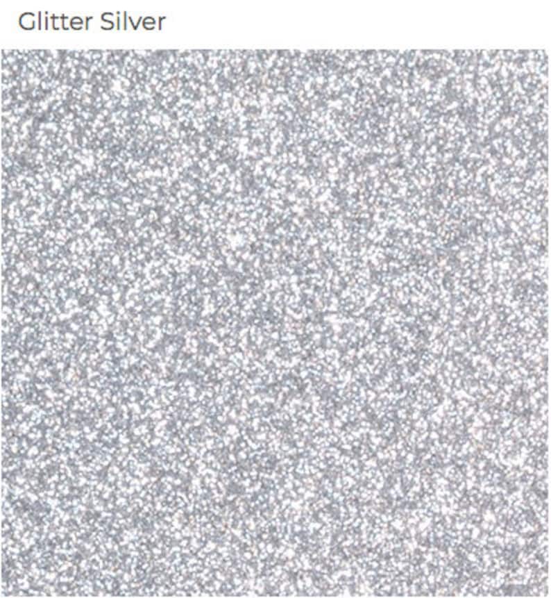May include: Silver glitter background with a fine, sparkly texture.