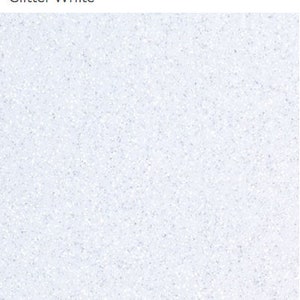 May include: A close-up of a white glitter surface. The glitter is fine and evenly distributed, creating a sparkling effect.