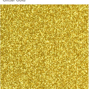 May include: A close-up of a gold glitter background. The glitter is very fine and creates a shimmering effect.