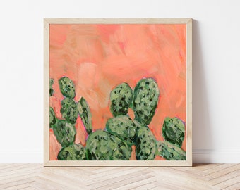 May include: A framed painting of a cactus plant with green leaves against a peach-colored background.