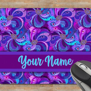 May include: Purple and blue mouse mat with a paisley pattern and the text "Your Name" in turquoise.