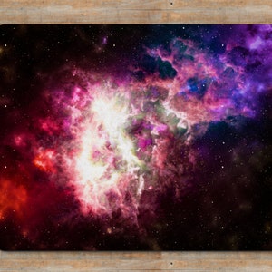 May include: A vibrant nebula with swirling clouds of pink, purple, and red against a dark blue starry background.