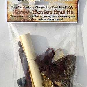 May include: A clear plastic bag containing a spell kit for removing barriers. The kit includes a rolled up parchment, a small bottle of oil, a brown pouch with herbs, a gold star charm, and a clear crystal.