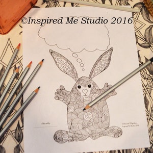 May include: A black and white line drawing of a rabbit with a thought bubble above its head. The rabbit is drawn with a lot of detail and has a cute, cartoonish expression. The text "Inspired Me Studio 2016" is at the top of the page.