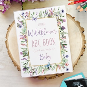 A little Wildflower themed baby shower guest book alternative. Shown on mockup of printed album with ultrasound at the bottom and flowers and coloring pencils at the top.