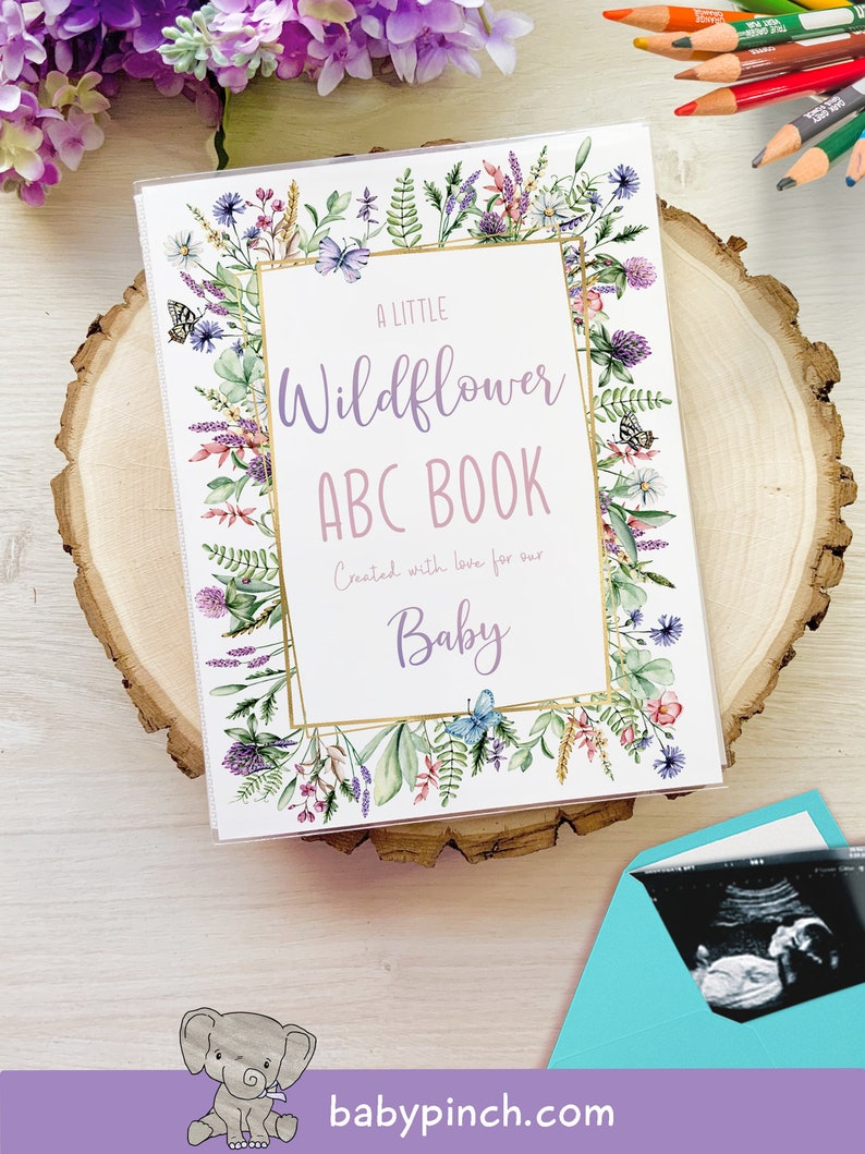 A little Wildflower themed baby shower guest book alternative. Shown on mockup of printed album with ultrasound at the bottom and flowers and coloring pencils at the top.