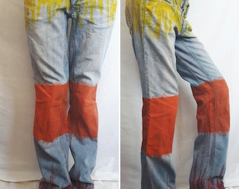 Hand painted jeans with low waist. Straight jeans painted in yellow, orange and red.