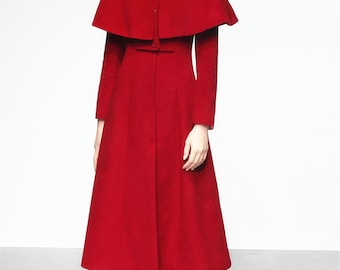 May include: A red wool coat with a cape collar and a button closure. The coat has a fitted bodice and a flared skirt.