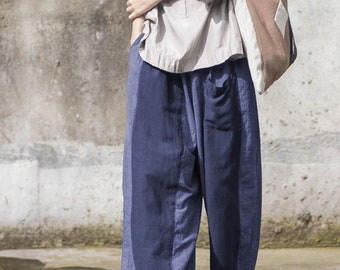 May include: A pair of wide-leg, blue linen pants with a patch pocket on the right side. The pants are made of a soft, comfortable fabric and have a relaxed fit.