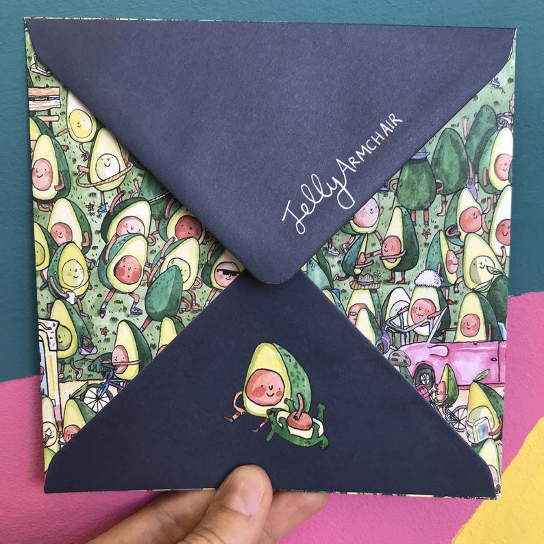 May include: A blue envelope with a pattern of cartoon avocados on the front. The envelope has the text "Jelly Armchair" written on the front in white.